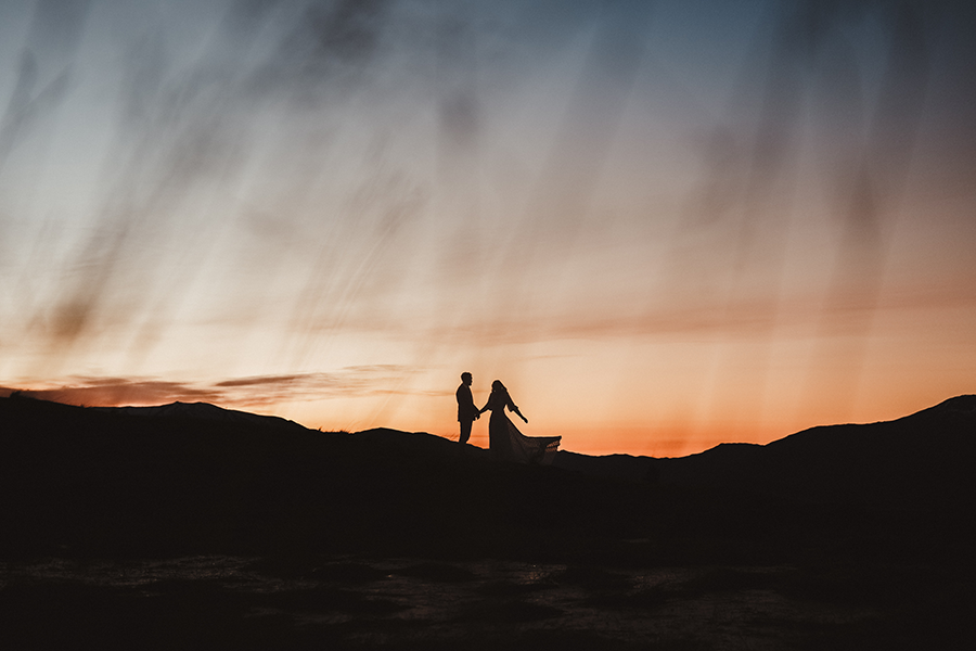 Silhouette of man and woman holding hands with sunset, illustrating Classic Chrome film simulation from Fujifilm.