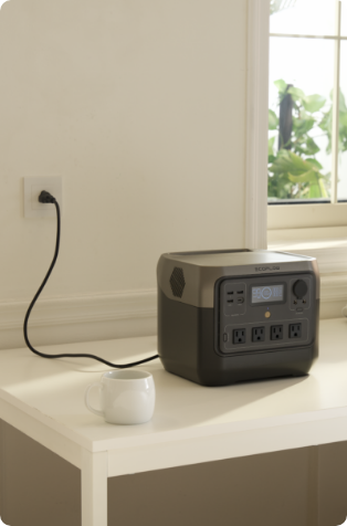 An image showing an EcoFlow RIVER 2 Pro Portable Power Station sitting on a countertop, plugged into a wall outlet.