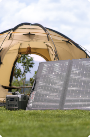 An image showing an EcoFlow RIVER 2 Pro Portable Power Station outside a tent being charged by a solar panel.
